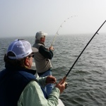 Two men are all concentration during fishing