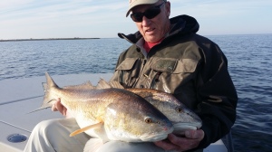 Man looks admiringly at the fish he has just caught