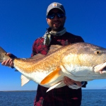 Man displays the capture from a February fishing trip