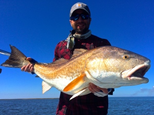 Man displays the capture from a February fishing trip