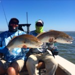 Men enjoying the spoils from a Big Redfish season