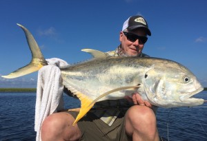 Man sitting with a large fish he caught