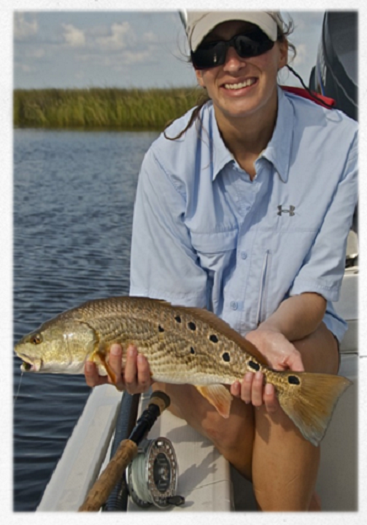 Lauren, a fishing guide, displays her catch