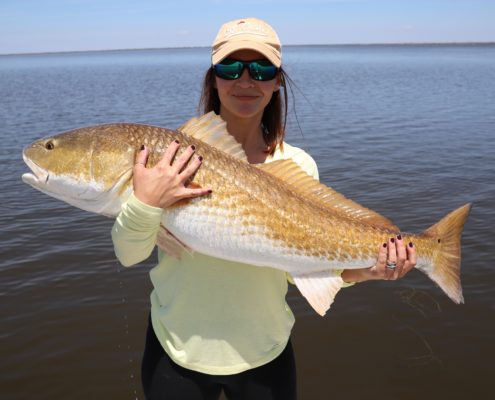 Lady displays her capture during a spring fishing trip