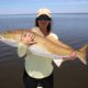 Lady displays her capture during a spring fishing trip