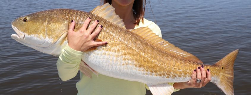 Lady displays her capture during a spring fishing trip