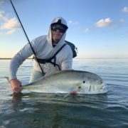 Man lifting up a large fish from the water